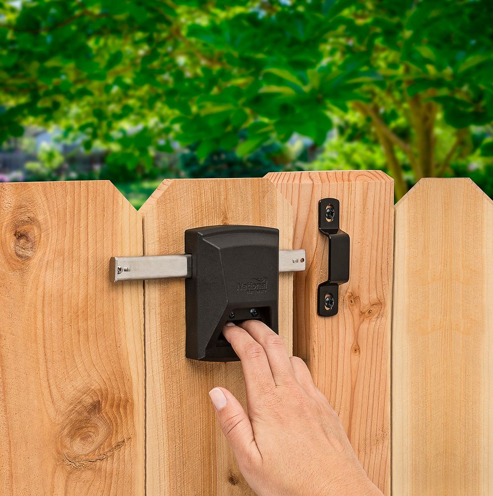 A locked metal door hook on white wooden door, simple device for home house  safety and protection Stock Photo